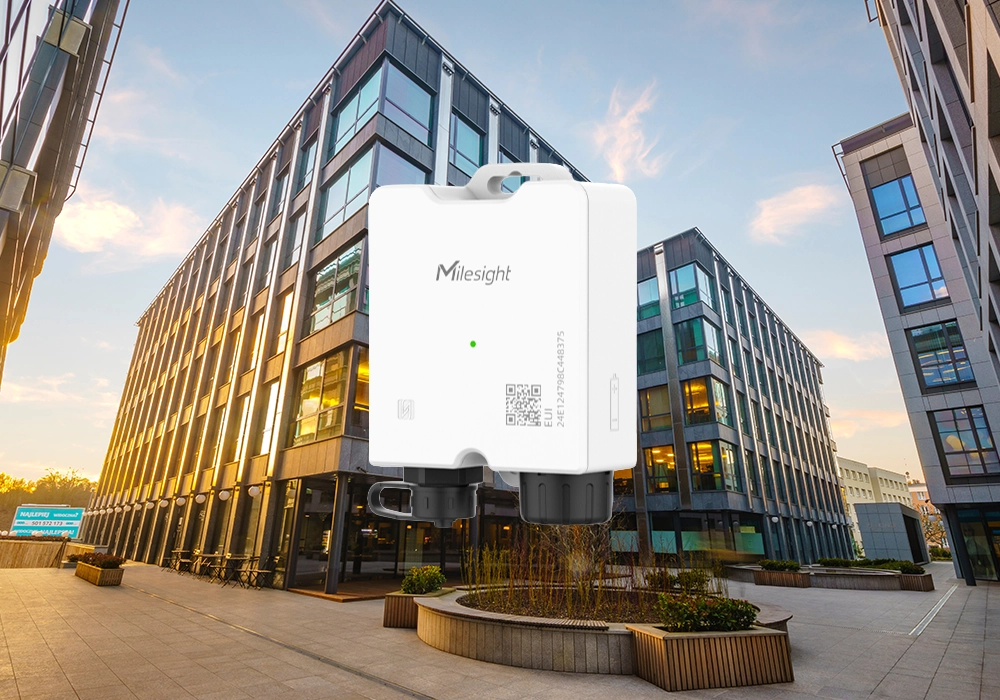 Milesight Cost-Effective Temperature Sensor. The background is a complex of buildings at sunset.