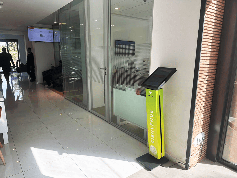 TIKK 15 ticket dispenser installed at CFG Bank’s entrance, seamlessly integrated into the branch environment.