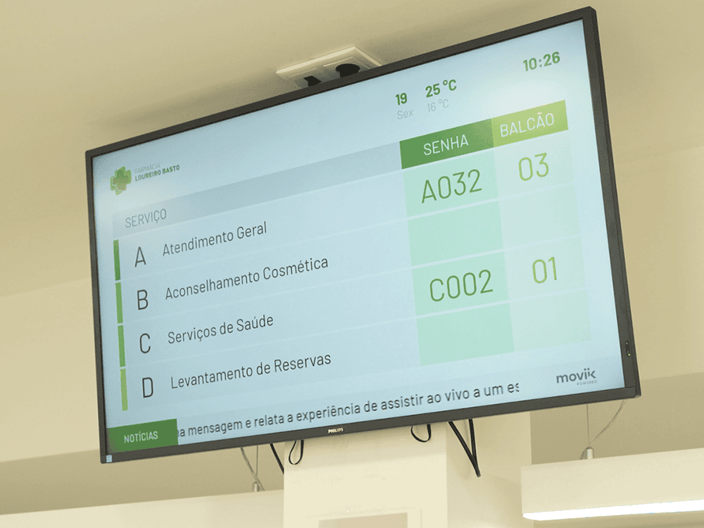 High-visibility signage player in the pharmacy lobby displaying real-time queue status and health information.