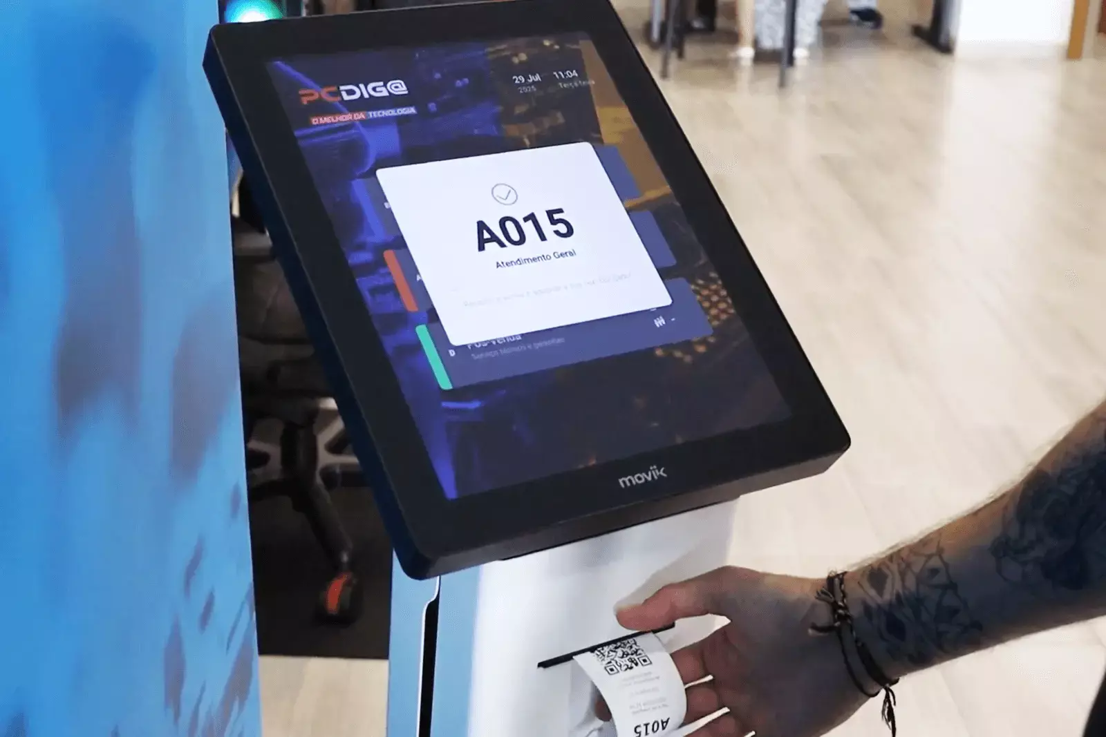 Customer using Moviik Tiik 15 kiosk to take a digital ticket in a retail store”