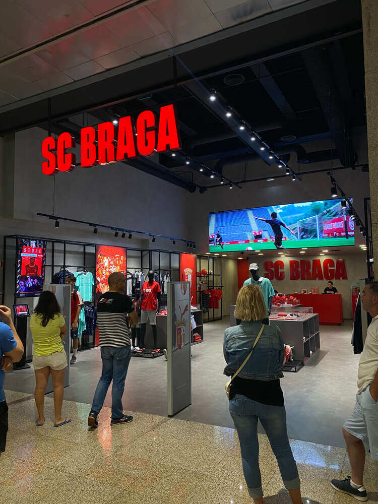 SC Braga official store entrance with fans waiting to enter and browse merchandise. SC Braga official store entrance with fans waiting to enter and browse merchandise.