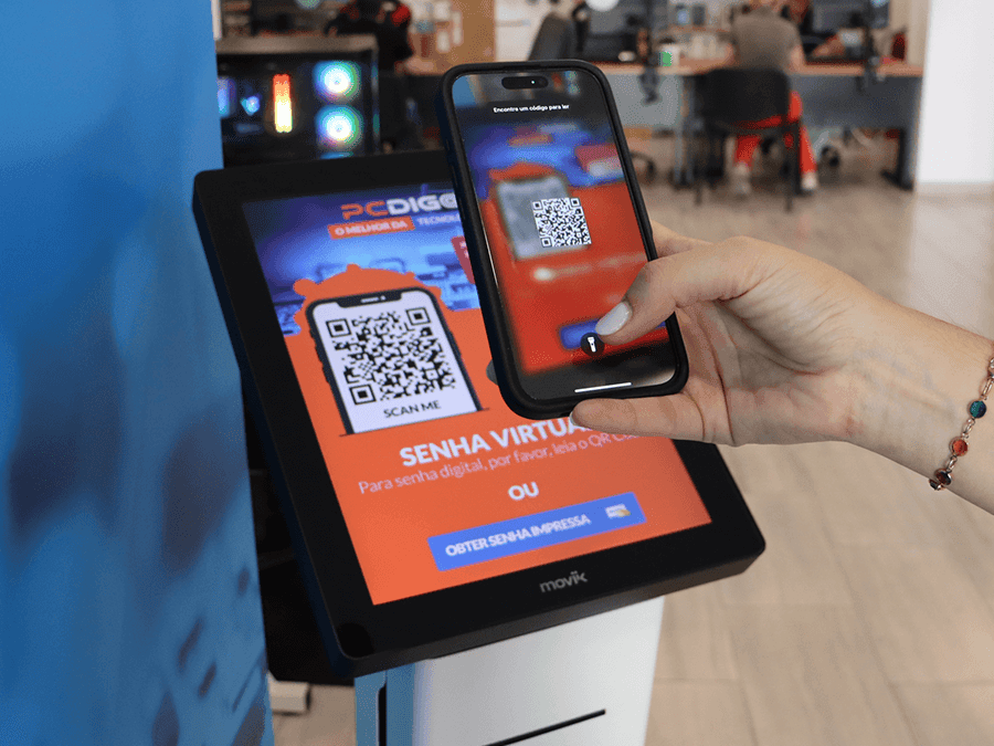 Person scanning a QR code with their smartphone to access the Moviik Digital Ticket web app.