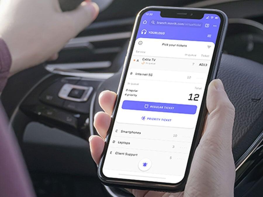 Staff member attending a customer at a service counter using Moviik’s Counter interface to manage tickets.