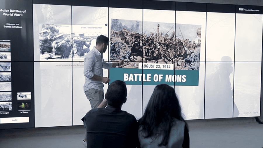 Front view of the DISPLAX TILE Pro 8×2 interactive video wall installed in a museum.