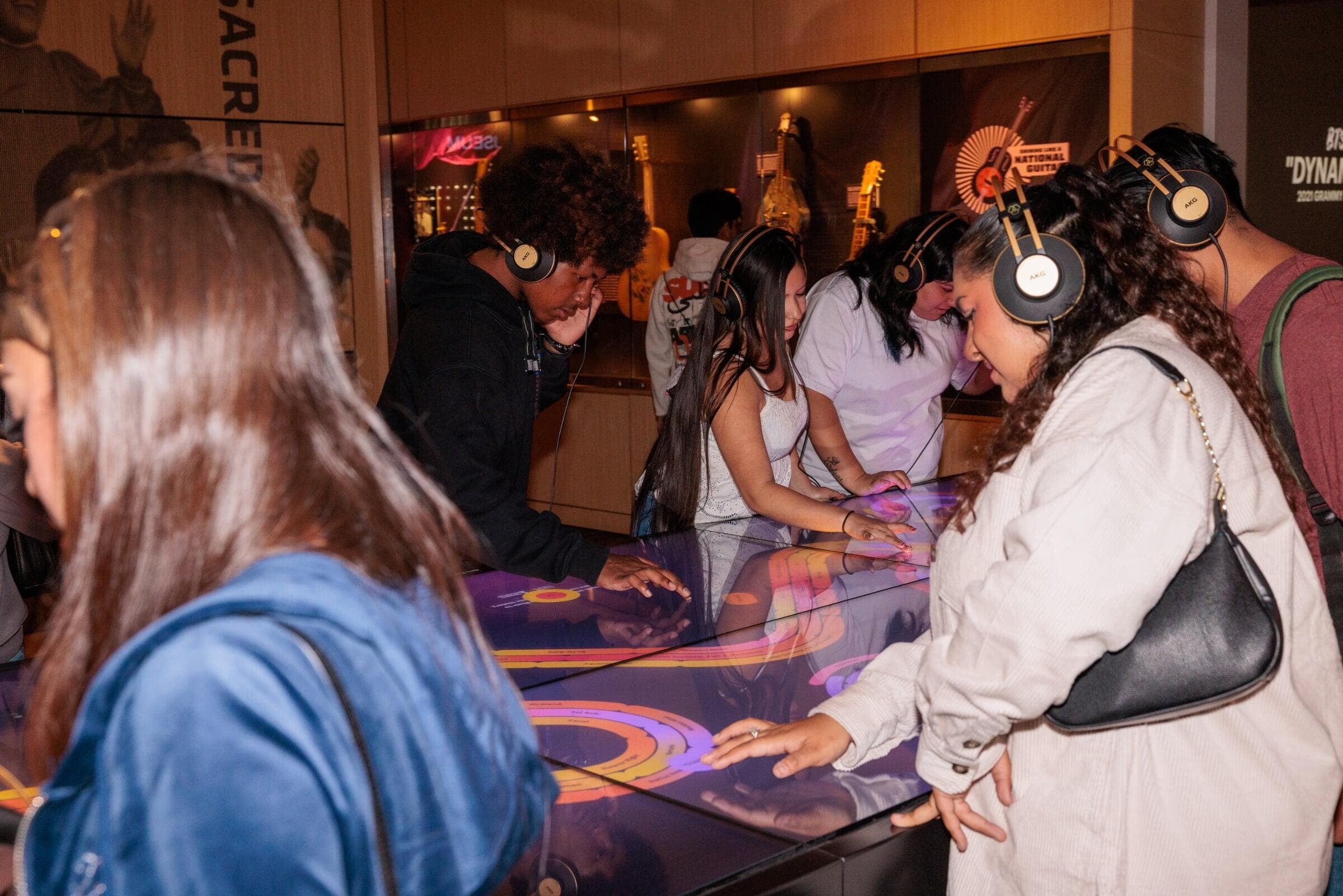 Multiple visitors interacting simultaneously with the Musical Crossroads touch table at the Grammy Museum. Multiple visitors interacting simultaneously with the Musical Crossroads touch table at the Grammy Museum.