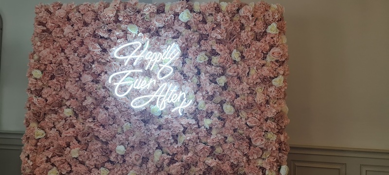 Flower wall with neon sign